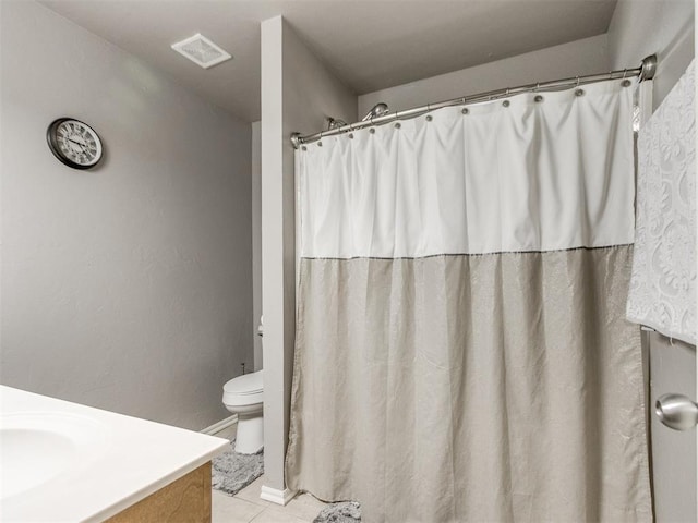 bathroom featuring toilet, tile patterned flooring, vanity, and visible vents