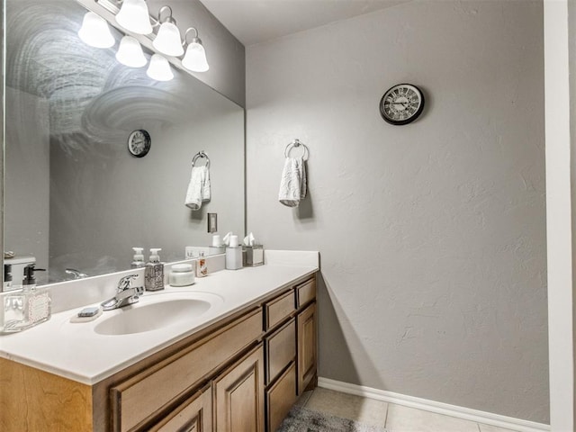 bathroom with tile patterned flooring, vanity, and baseboards