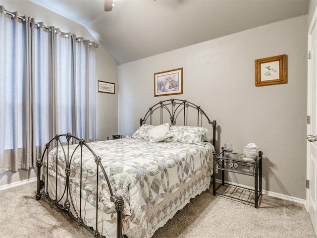 bedroom with carpet floors, vaulted ceiling, baseboards, and ceiling fan