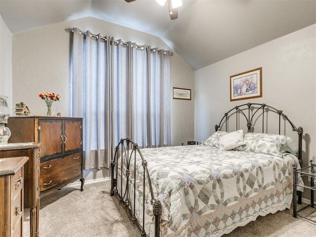 carpeted bedroom with ceiling fan and vaulted ceiling