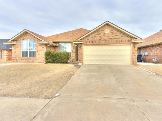 ranch-style home with concrete driveway, brick siding, roof with shingles, and an attached garage