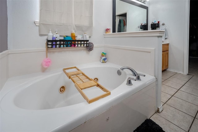 bathroom with vanity, tiled tub, and tile patterned floors