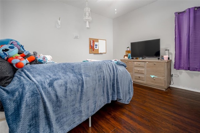 bedroom with dark hardwood / wood-style floors