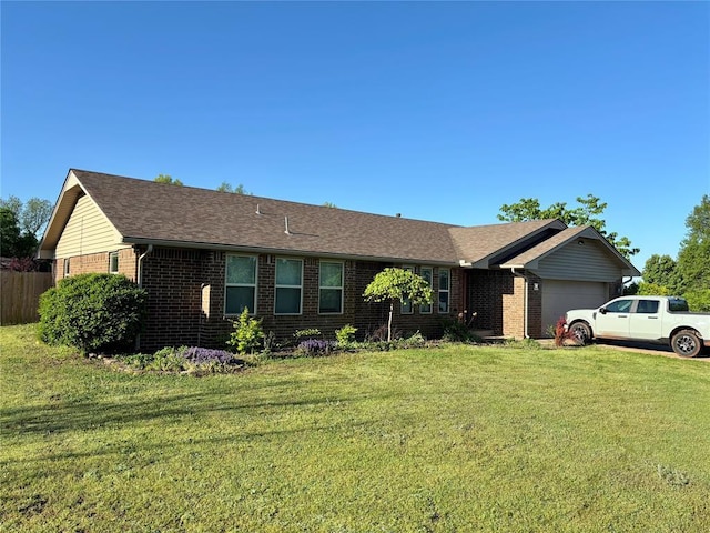 ranch-style home with fence, a front lawn, brick siding, and a garage