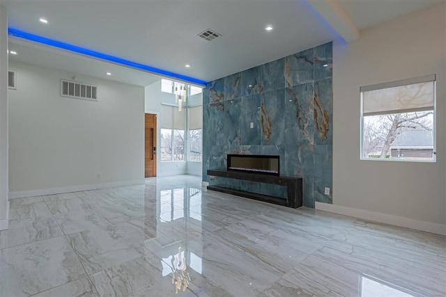 unfurnished living room featuring beamed ceiling and a fireplace