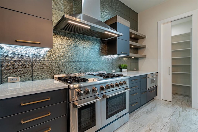 kitchen featuring wall chimney exhaust hood, appliances with stainless steel finishes, and tasteful backsplash