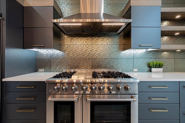 kitchen with double oven range, backsplash, and wall chimney exhaust hood