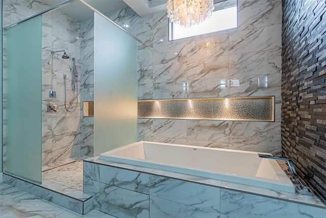 bathroom featuring shower with separate bathtub and a notable chandelier