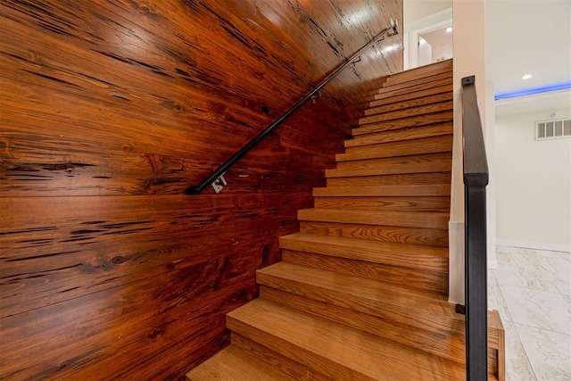 staircase with wood ceiling and rail lighting