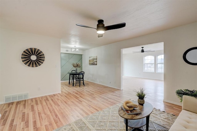 living room with wood-type flooring and a notable chandelier