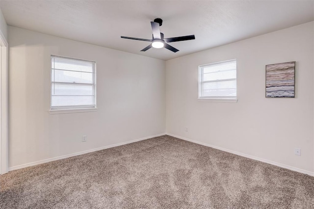 unfurnished room with ceiling fan and carpet flooring