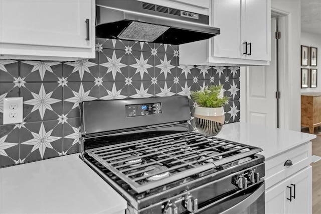 kitchen with white cabinetry, backsplash, and range with gas cooktop