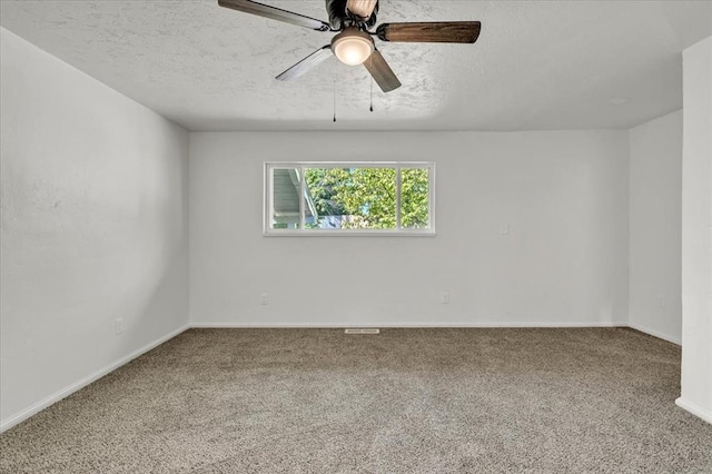 carpeted spare room with ceiling fan and a textured ceiling