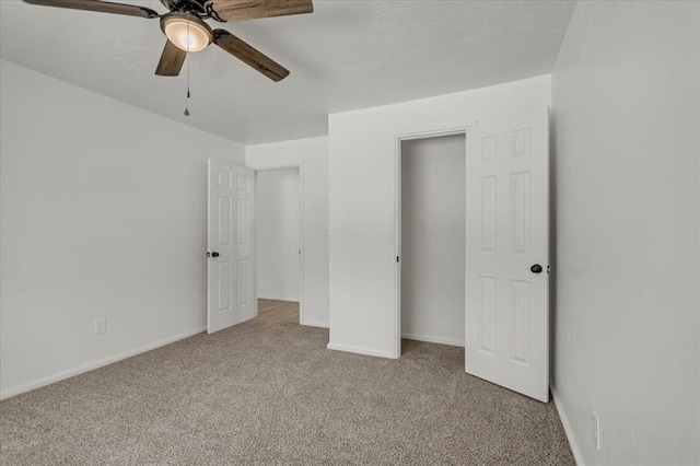 unfurnished bedroom featuring ceiling fan and light carpet