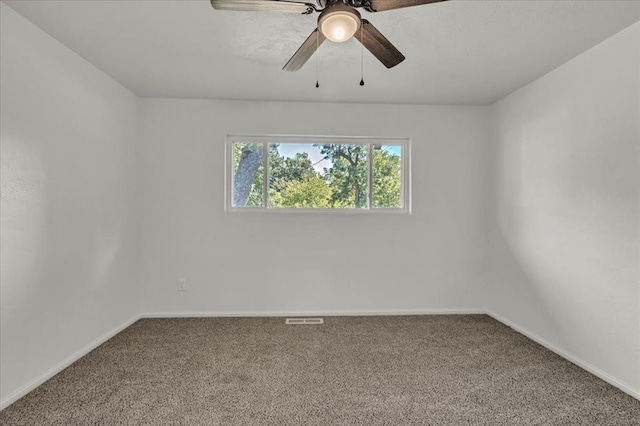 spare room featuring ceiling fan and carpet floors