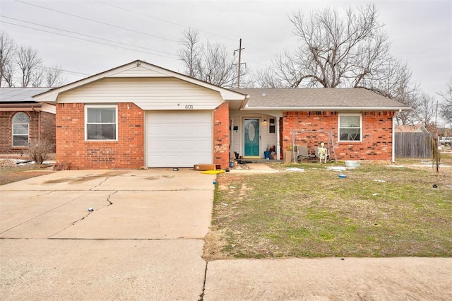 single story home with brick siding, fence, a garage, driveway, and a front lawn