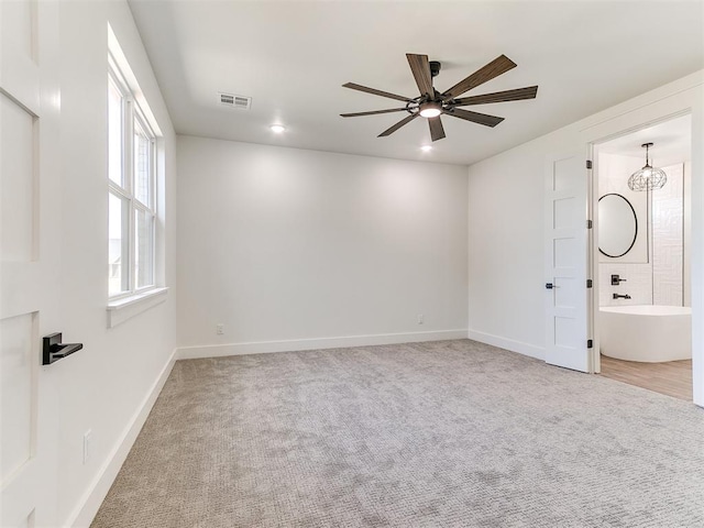 spare room with ceiling fan, visible vents, baseboards, light carpet, and recessed lighting