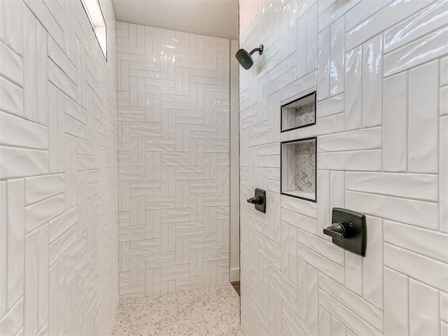 full bath featuring tiled shower