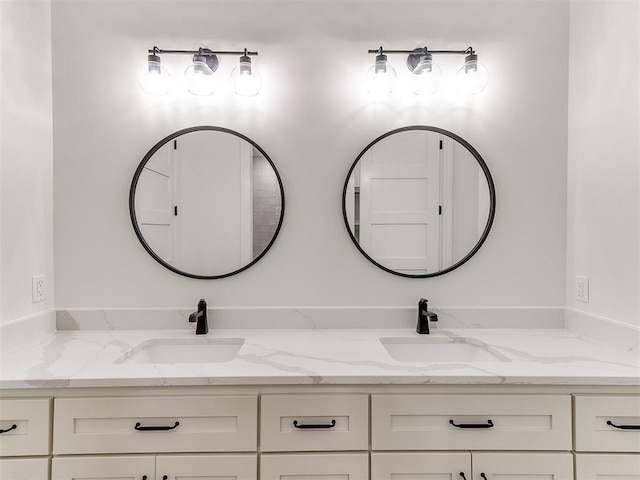 bathroom with a sink and double vanity