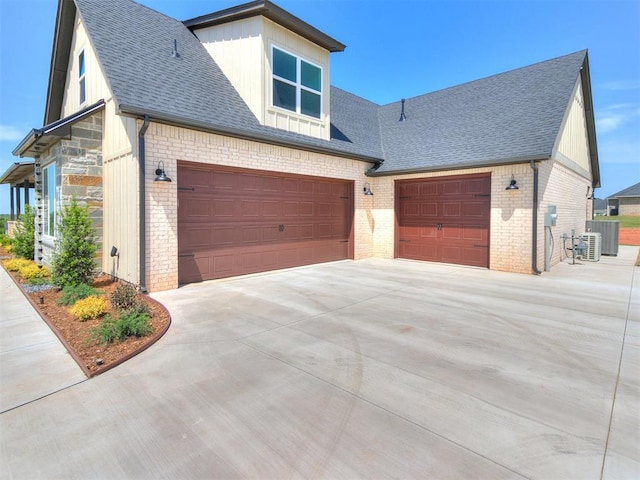 view of front of house with brick siding, a shingled roof, and driveway