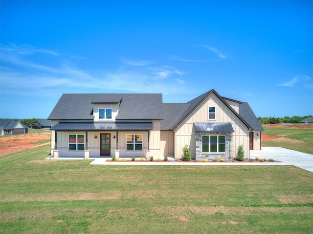 modern farmhouse featuring board and batten siding, a porch, and a front lawn