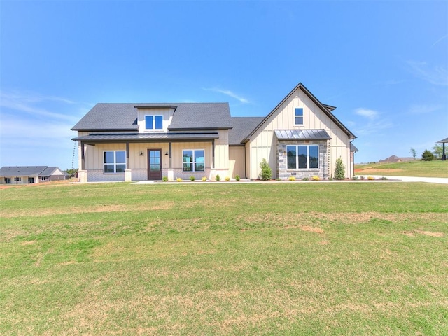 modern inspired farmhouse with a porch, a shingled roof, a front lawn, and board and batten siding