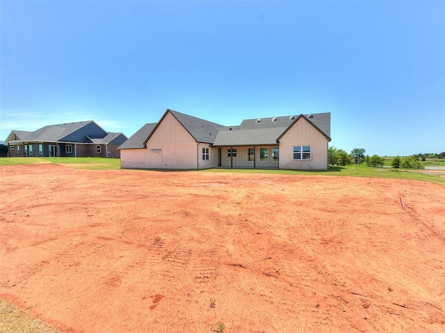 back of property with board and batten siding