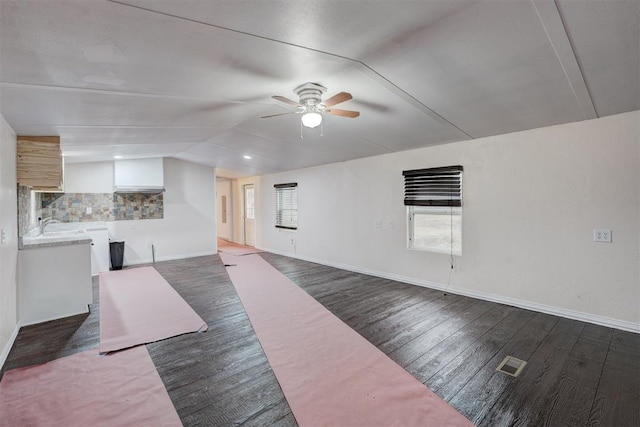 unfurnished living room with ceiling fan, lofted ceiling, and dark hardwood / wood-style floors