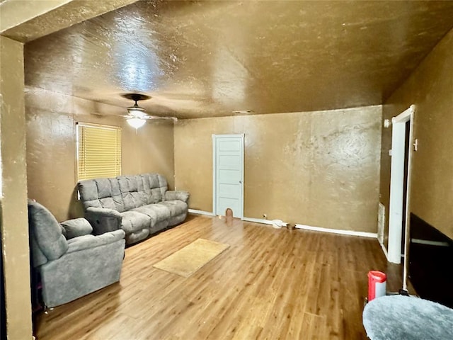 living room with wood-type flooring and ceiling fan