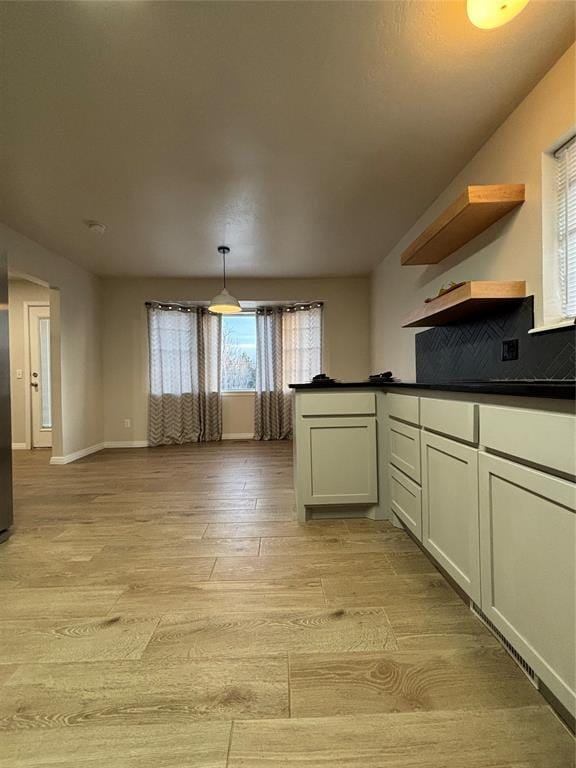 kitchen featuring decorative light fixtures and light hardwood / wood-style floors