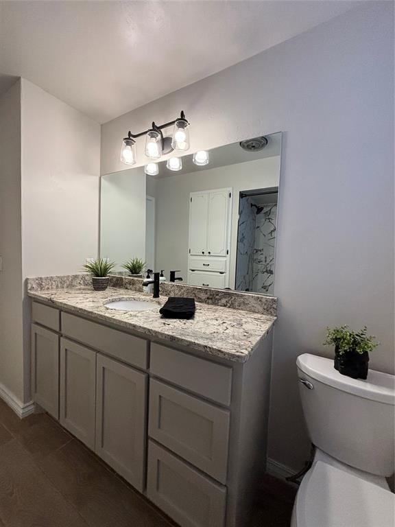 bathroom featuring vanity and toilet