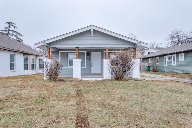 1617 NW 31st St, Oklahoma City, OK 73118 - bungalow-style house featuring a front yard and a porch