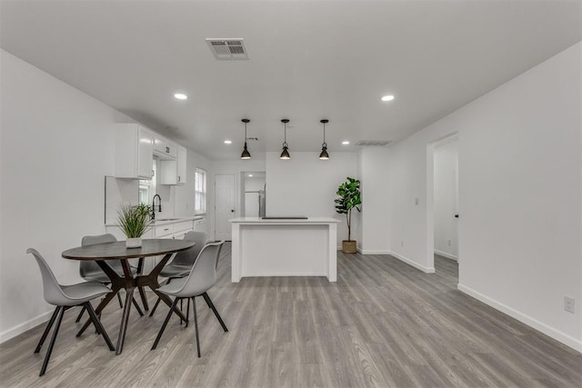 1617 NW 31st St, Oklahoma City, OK 73118 - dining space featuring sink and light hardwood / wood-style flooring