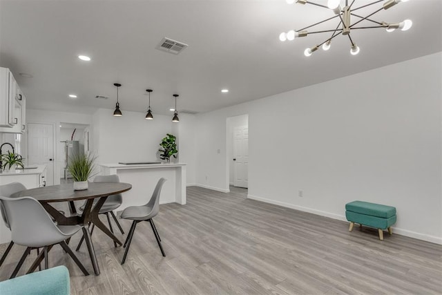 1617 NW 31st St, Oklahoma City, OK 73118 - dining space with light hardwood / wood-style floors and a notable chandelier