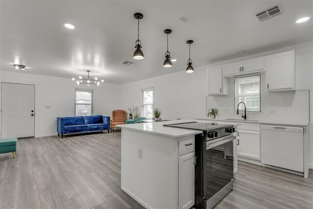 1617 NW 31st St, Oklahoma City, OK 73118 - kitchen with sink, stainless steel range with electric stovetop, hanging light fixtures, dishwasher, and white cabinets