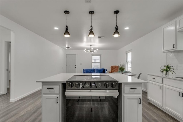 1617 NW 31st St, Oklahoma City, OK 73118 - kitchen featuring pendant lighting, white cabinets, decorative backsplash, and electric range