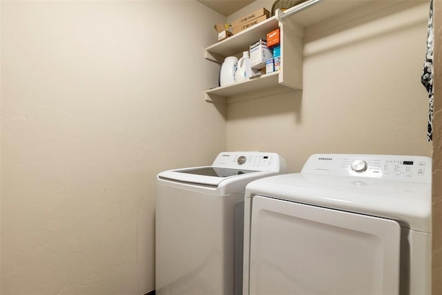 washroom featuring washer and clothes dryer