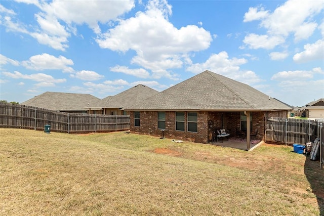 back of house featuring a yard and a patio area