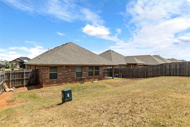 rear view of house featuring a yard