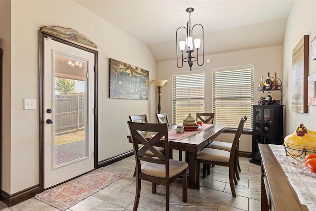 dining room featuring vaulted ceiling and a chandelier