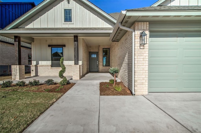 doorway to property with a garage and a porch