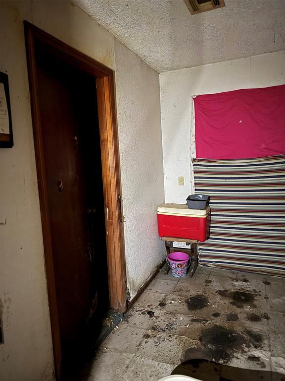 miscellaneous room with a textured ceiling