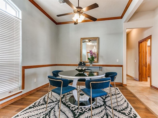 2508 Hamden Ave, Norman, OK 73069 - dining space with crown molding, baseboards, ceiling fan, and wood finished floors