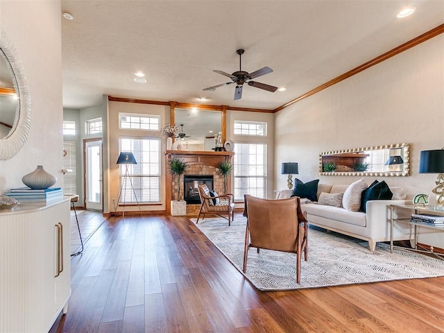 2508 Hamden Ave, Norman, OK 73069 - living room with crown molding, a glass covered fireplace, a ceiling fan, recessed lighting, and wood finished floors