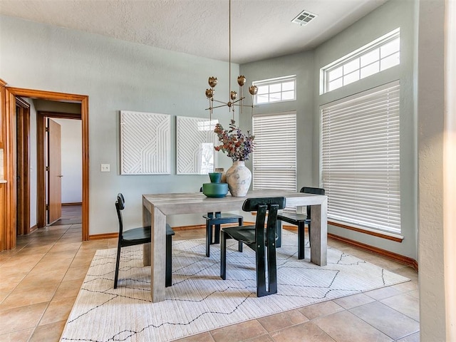 2508 Hamden Ave, Norman, OK 73069 - dining room featuring an inviting chandelier, baseboards, light tile patterned floors, and a textured ceiling