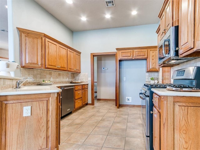 2508 Hamden Ave, Norman, OK 73069 - kitchen featuring light countertops, decorative backsplash, stainless steel appliances, and visible vents