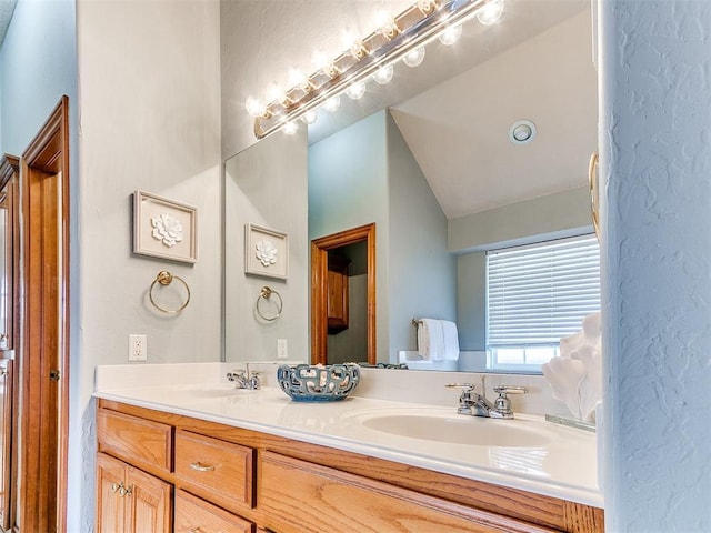 2508 Hamden Ave, Norman, OK 73069 - full bath with a sink, a textured wall, double vanity, and lofted ceiling