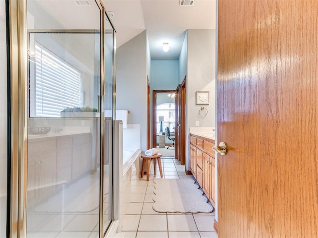 2508 Hamden Ave, Norman, OK 73069 - bathroom with visible vents, a healthy amount of sunlight, tile patterned flooring, and vanity