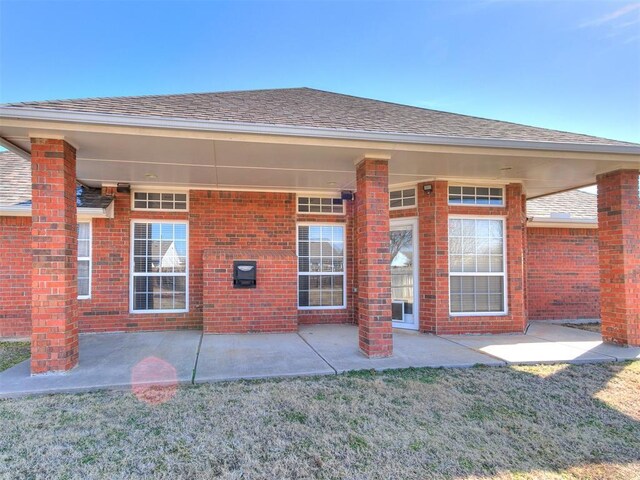 2508 Hamden Ave, Norman, OK 73069 - rear view of property featuring brick siding, a shingled roof, and a patio area