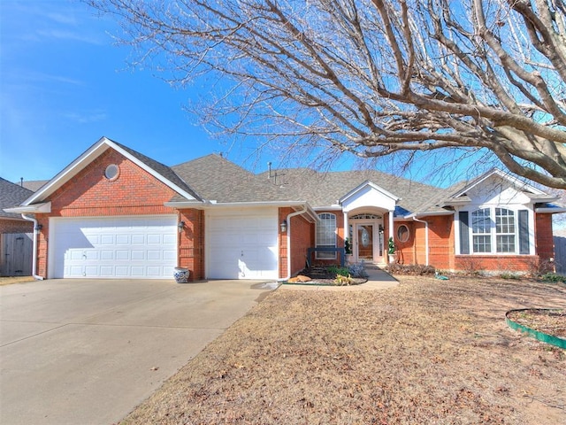 2508 Hamden Ave, Norman, OK 73069 - ranch-style house with brick siding, driveway, roof with shingles, and a garage